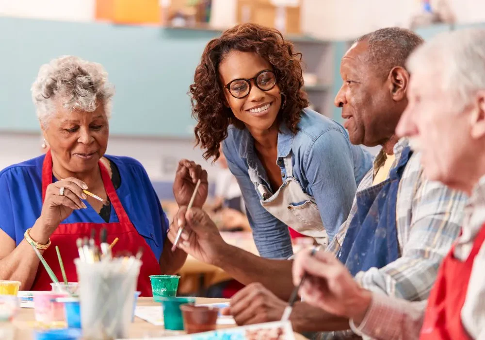 A group of seniors establishing social connection and purpose by attending an art class for senior citizens