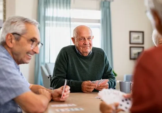 A group of 80- to 90-year-old men playing card games against each other happily