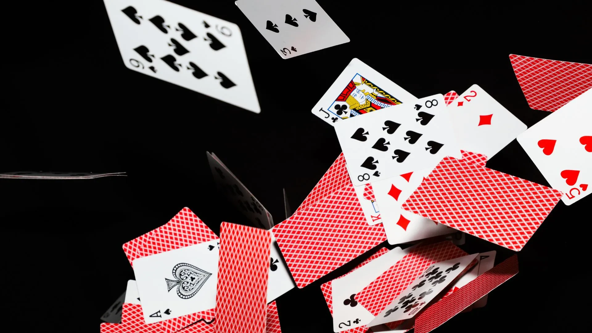 A deck of cards scattered in the air