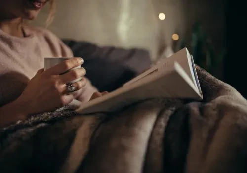 Someone reading a book to unwind