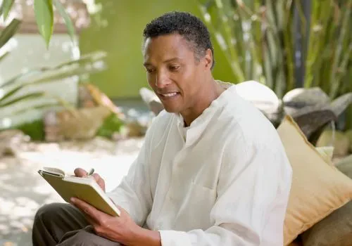 A man journaling to keep his hands and mind busy